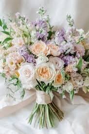Flower bouquet in lilac, pale yellow with greenery sitting on the bed at getting ready at Cote dazur