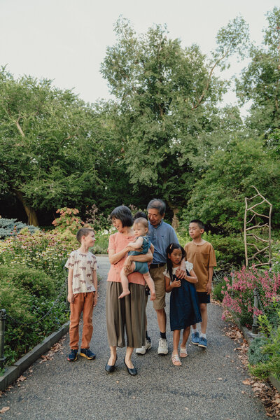 grandparents walk with their grand kids in fort tyron park
