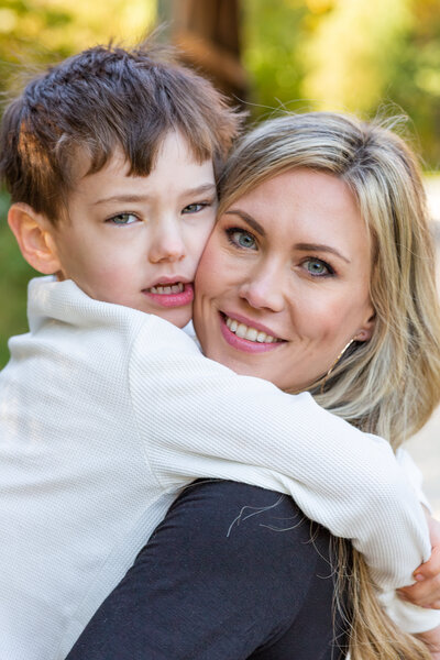 A mother and son hug at a photo session at The Bridge to Antiquity with Ron Schroll Photography in Davidson, NC