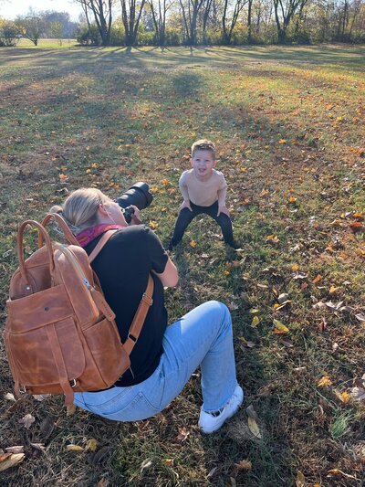 Candid moment of Jennifer Mosier photographing a toddler in motion at a local park