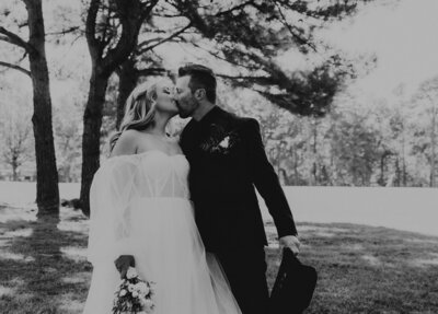 Bride and Groom kissing during wedding ceremony at The Rosewood Venue in Mount Vernon, Texas.