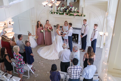 Wedding ceremony in the grand room by fireplace