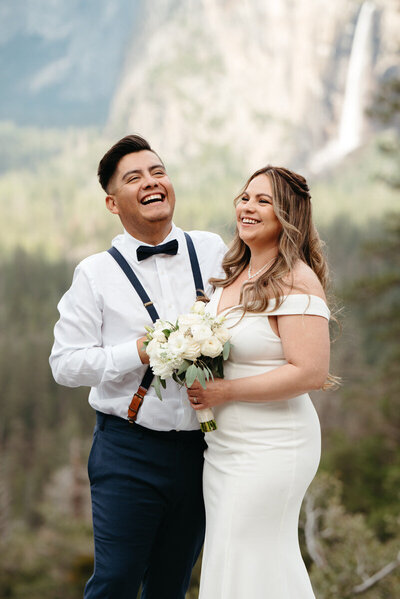 Close up of wedding couple who left this review for the Chaffins laughing with joy at Yosemite