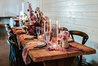Rustic Wood Table with Fresh Floral Centerpiece at Reception at The Rosewood Venue