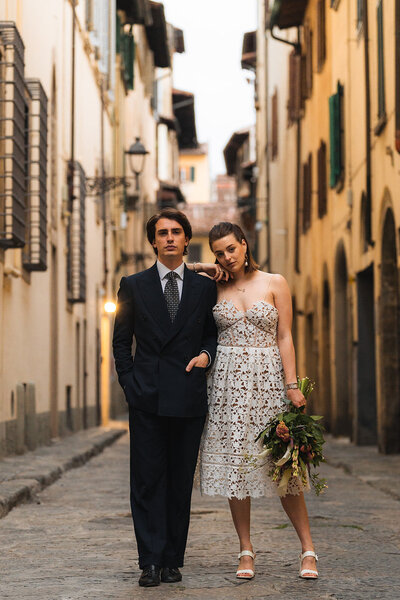 a bride and groom standing together after elopeing in the streets of florence italy