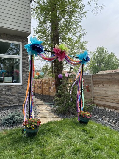 A rectangular arch with colorful ribbons on it.