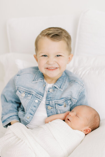 two siblings posing in photography studio spokane