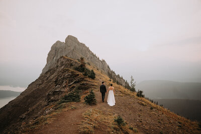 wedding couple hiking up a mountain in kananaskis