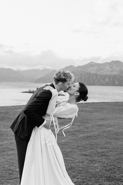 Bride in a vinka design dress looking off into the distance towards a big mountain view at Rippon