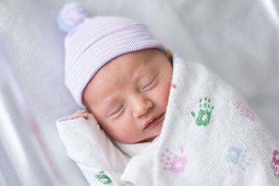 newborn baby swaddled in hospital blanket at fresh 48 newborn session