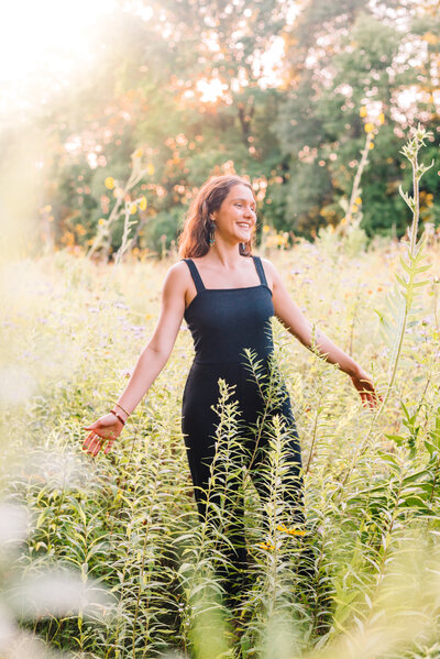 Ariane smiling in a filed of wildflowers