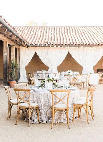 Wedding table layout at a wedding with wood chairs