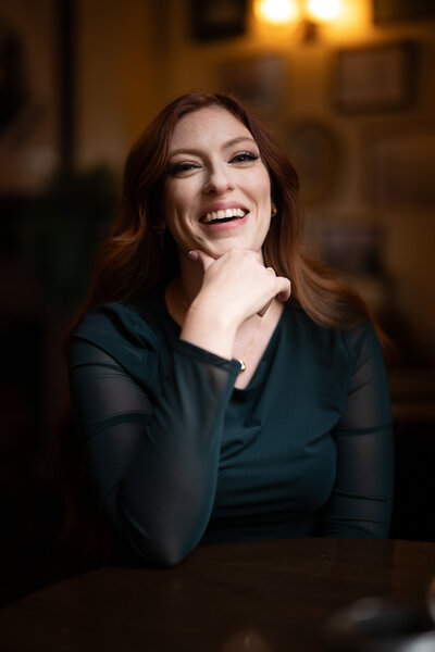 Image of Sarah Kenyon laughing at the bar.