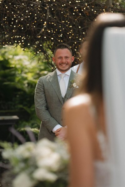 Groom gets emotional as his bride comes up the aisle towards him