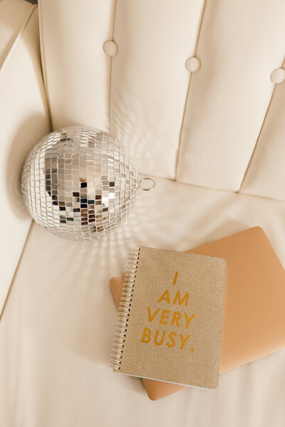 Couch with disco ball, laptop, notebook