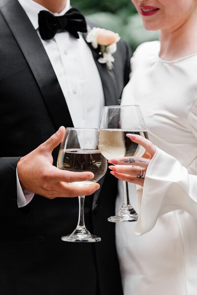 bride and groom cheersing their glasses