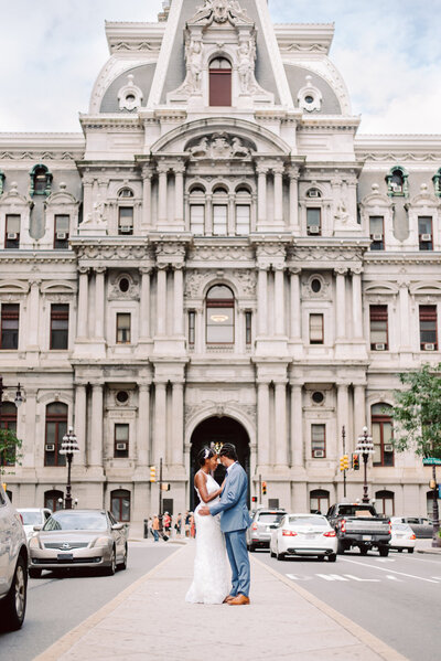 A couple stands in front of City Hall
