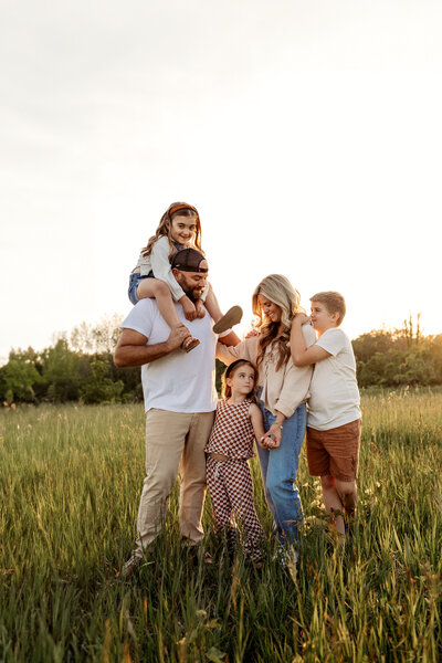 Family in feild at sunset