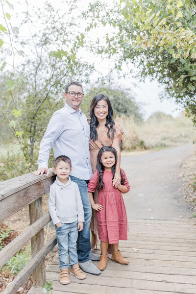 family hugging on a bridge during sunset by Caroline Bendel, Sacramento family photographer