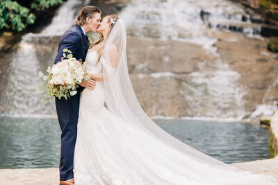 Bride & Groom kiss in front of waterwall,  North GA Mountain Wedding, Chota Falls, Georgia Waterfall Venues.