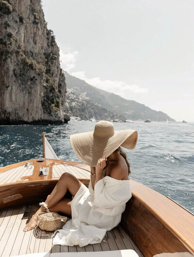 Woman solo traveler embracing a serene Adriatic coast adventure by boat.