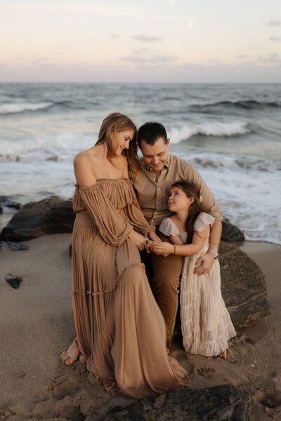 Miami family photographer: capturing a loving family at sunset on a beautiful beach, with ocean waves