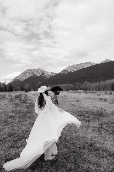 Bride dancing in the mountains during a destination wedding in Banff, Canada — cinematic, story-led wedding photography.