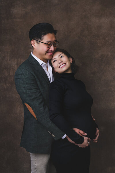 Tender expecting couple holding baby bump — refined maternity photography in the Bay Area