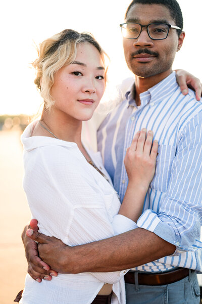 Louisville couple hugs during their engagement session at the Crescent Hill Reservoir