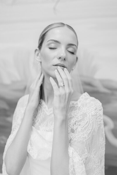 A bride touches her lips passionately.