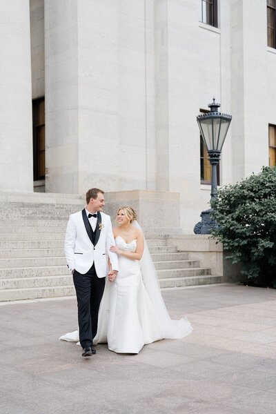 The Westin wedding venue with bride and groom holding hands and walking together photographed by Columbus wedding photographer