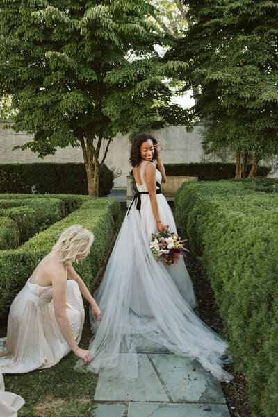 Jessica Bennett wedding planner arranging bride's Carol Hannah gown at the War Memorial in Grosse Pointe Michigan in Detroit