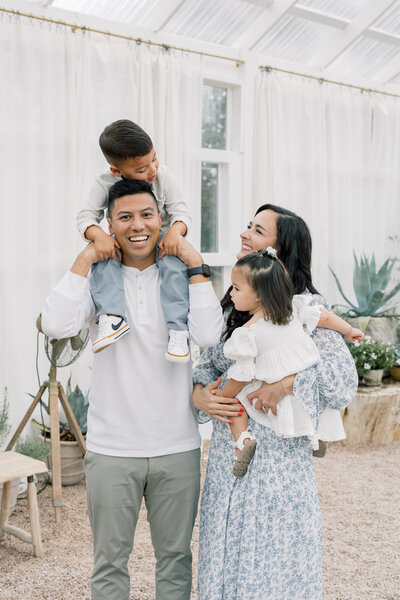 Outdoor family portrait with parents and two young children – Charlotte family photographer – Katie Petrick Photography