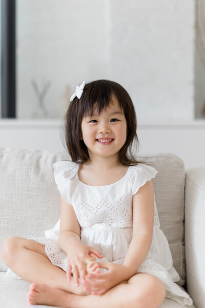 Little girl sitting on couch at NYC family photography session