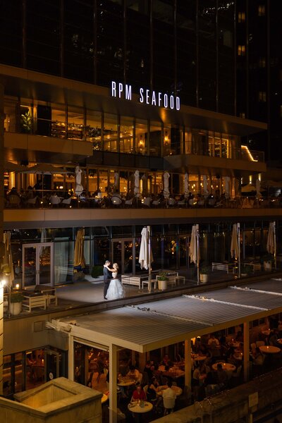 Night portrait of Bride and Groom dancing outside of RPM Events 