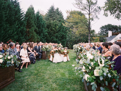 Private Alexandria residence wedding ceremony with flower girls walking down the aisle