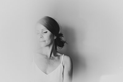 Artistic shadowed portrait of Shannon Kathleen, Minneapolis photographer specializing in dating and branding photos.