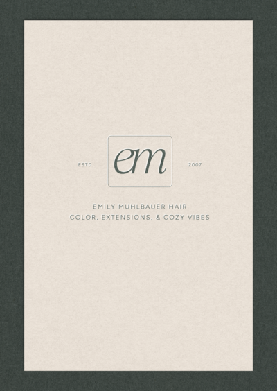 A mock-up of Emily’s primary logo printed on textured paper.