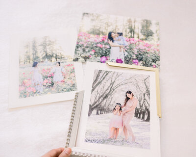 Collection of mounted mom-and-child portrait samples with frame corner options displayed during client design consultation