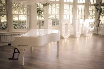 semigrand white baby grand piano shell hire