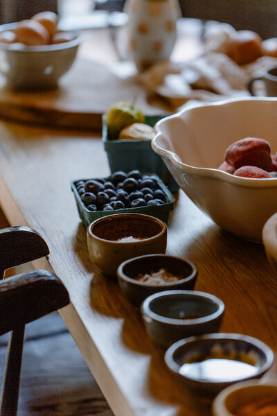 Blueberries and other foods portioned on the kitchen table