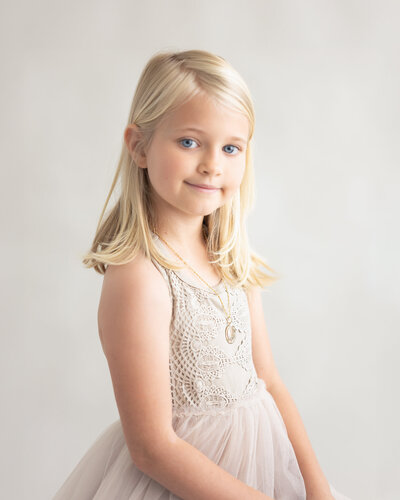 beautiful blonde child in neutral dress and background captured by Allison Amores Photography