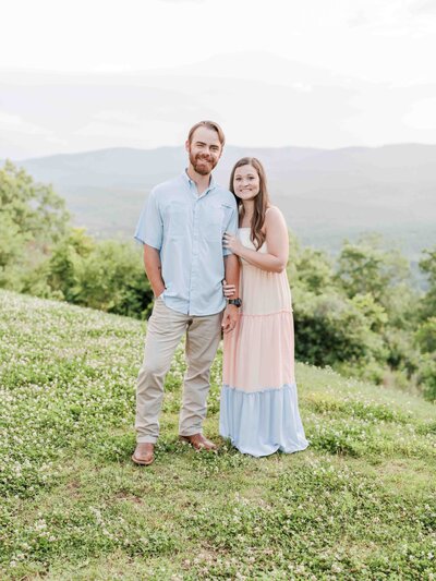 engaged couple embracing in moutains