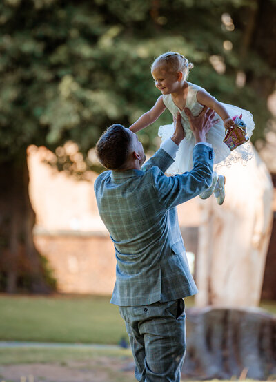 Groom playing with daughter in Astley Park captured by Anthony Horseman Photography and Film