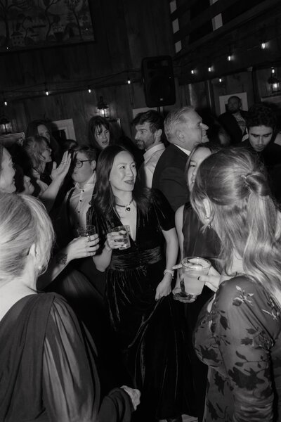 The reflection of a wedding guest in a mirror at Farm Road Estate in West Dover Vermont
