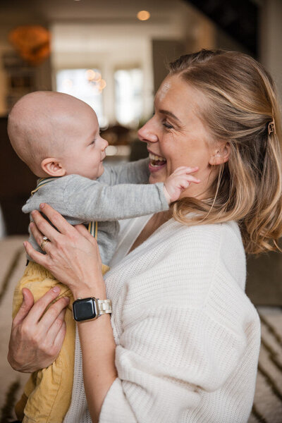Mother and baby at home embracing for a hug. Image by Alyx Jones Photography. 