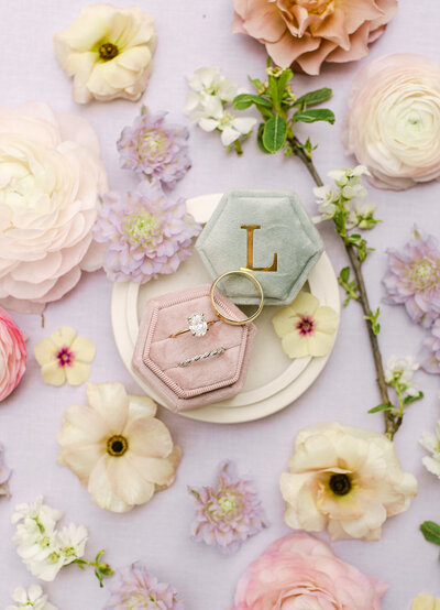 wedding detail photo with ring boxes and flowers