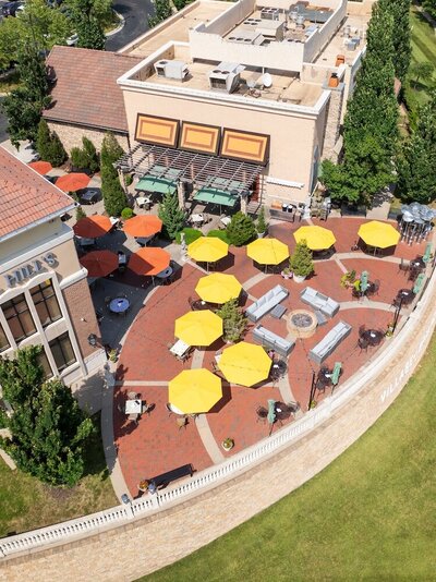 An aerial view of the yellow and orange table umbrellas at Briarcliff Village