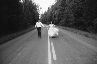 happy bride and groom running up quiet road, destination wedding photography