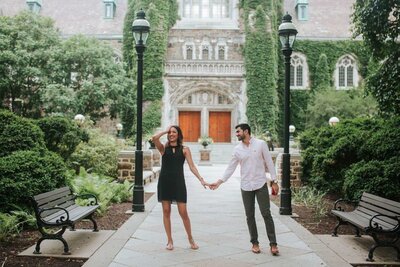 Lehigh Valley engagement session couple holding hands while groom glances at wife-to-be.